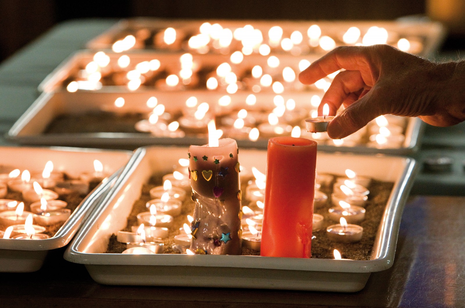 107_atimetoremember_bodyimage3 Mourners light candles at a special service at the Holy Trinity Anglican Church in Greymouth following the news of a second explosion in the Pike River mine on November 24.