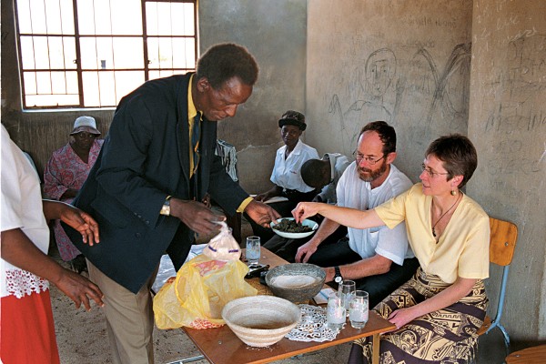 Sue Baker and Tom Lacey, advisers on human resource management, enjoy the hospitality of the Bulilimamangwe Rural District Council in Plumtree, western Zimbabwe. 