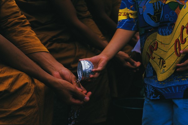 For Thai Buddhists,Songkran, the New Year, is a day of cleansing. In Thailand, the idea is taken to extremes as fire trucks drive down city streets, liberally watering all and sundry. At the Wat Yarnprateep in Te Atatu, more restraint is shown: members of the Thai community queue to wash the hands and feet of the four resident monks.