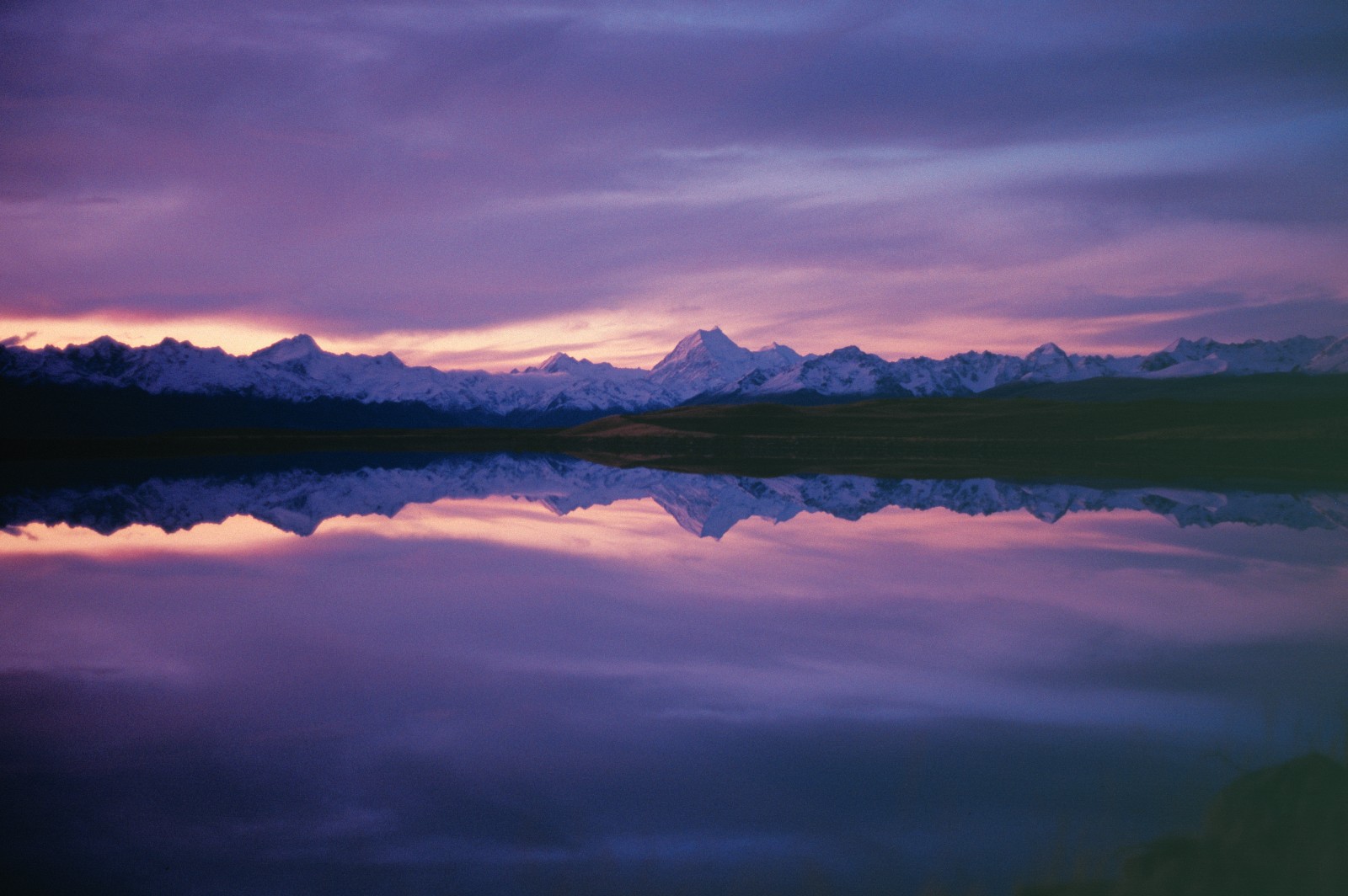 51_Waitaki_09 One of the most photographed vistas in New Zealand: Aoraki (Mt Cook) and surrounding mountains reflected in the Tekapo Canal, which flows into Lake Pukaki. The level of the lake was raised 37 m to more than double its storage capacity for hydro generation during the upper Waitaki development in the 1970s and early 1980s.