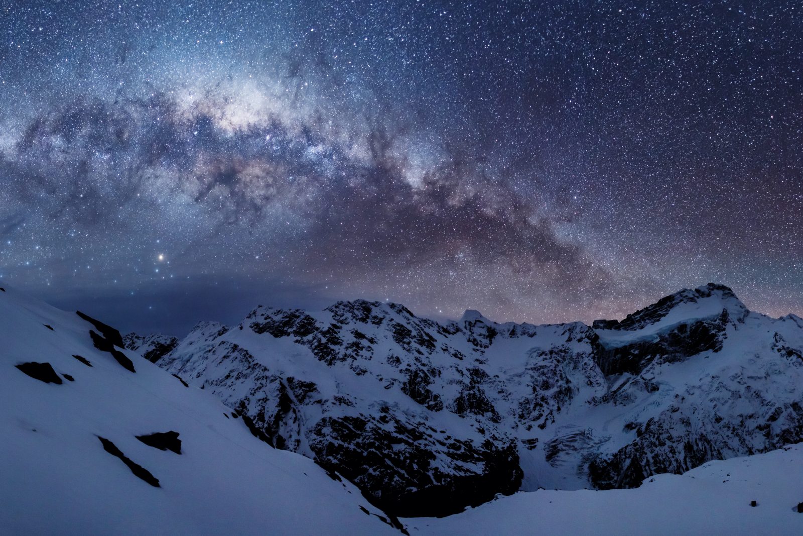 126_Astro_01 The Sierra Range, a rampart of the Southern Alps, bathes in starlight. This massive wall of rock is largely responsible for the extraordinarily clear skies over Canterbury. The westerly wind cools as it rises over the snowy turrets, condensing the moisture that falls as snow or rain, predominantly west of the range, leaving the leeward side dry, clear and low in humidity—vital ingredients for stargazing.